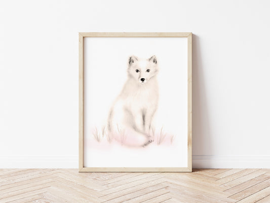 Drawing of an arctic snow fox in tones of sepia beige and blush pink on a plain, white background. The print is in a light wood frame and sits on a wood floor. Studio Q - Art by Nicky Quartermaine Scott