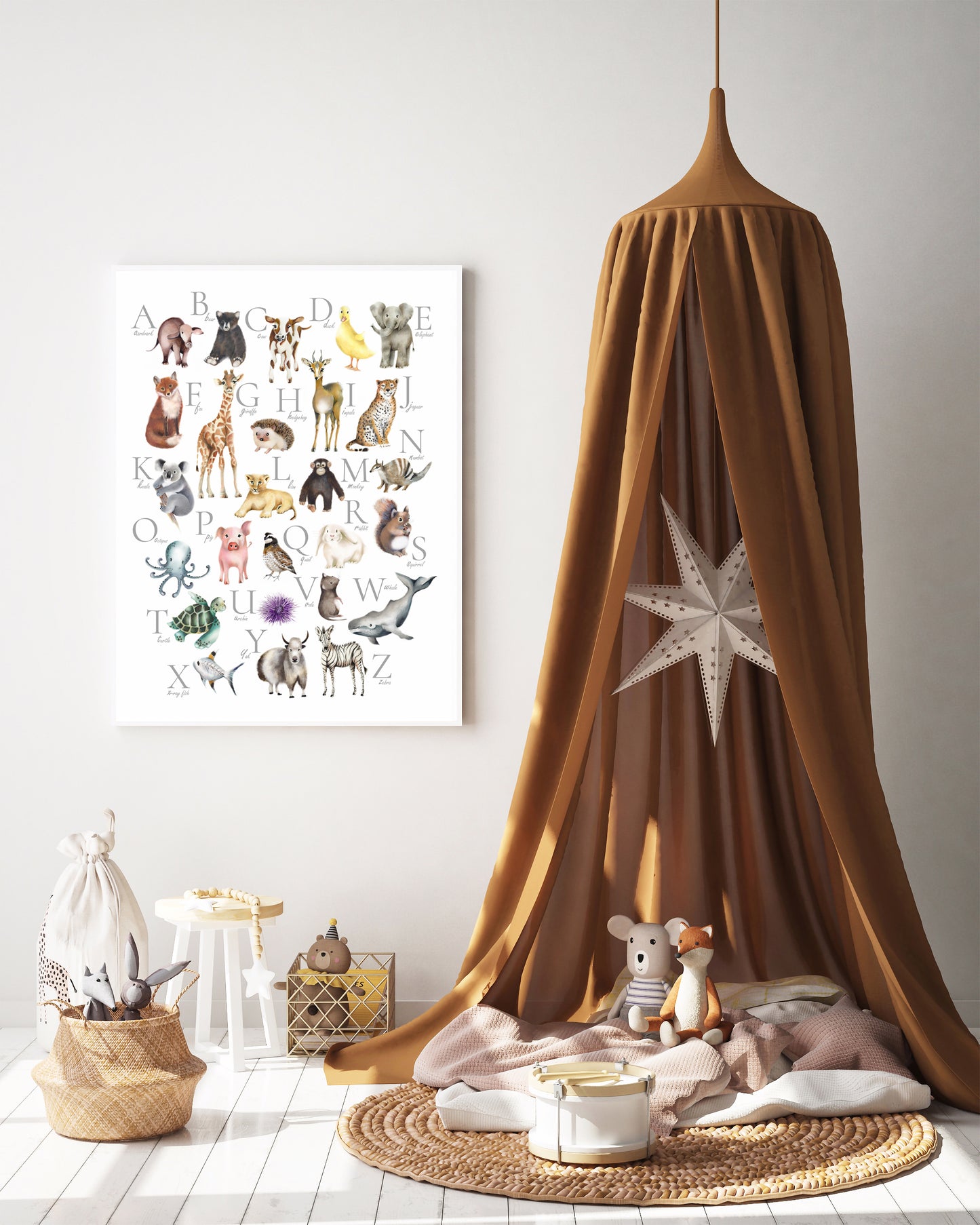 Kids ABC alphabet poster with colorful baby animals. Print is mounted in a white frame and sits against a grey background. In the foreground is a rust colored tent with a star and some kids toys on the floor beneath it - Studio Q - Art by Nicky Quartermaine Scott
