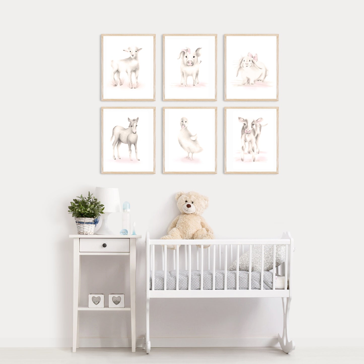 Set of 6 Baby farm animal prints in beiges and pink hanging on a wall in wood frames above a crib - Studio Q  - Art by Nicky Quartermaine Scott